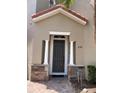 Inviting entryway with stone accents and a covered porch, leading to the front door at 833 Brunello Dr, Davenport, FL 33897