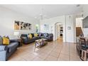 Spacious living room featuring tile floors, a ceiling fan, and an open floor plan at 833 Brunello Dr, Davenport, FL 33897