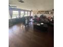 Spacious living room with hardwood floors, large windows and two sofas at 848 Wildabon Ave, Lake Wales, FL 33853