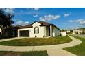 Beautifully landscaped corner lot featuring a charming single-story home, complemented by a neatly kept lawn and inviting sidewalk at 1025 Belvoir Dr, Kissimmee, FL 34744
