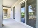 Spacious balcony featuring sliding glass doors and views of the community's greenery at 11037 Bagley Aly, Windermere, FL 34786