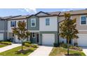 Exterior view of an inviting townhome with a well-kept lawn and a private driveway at 1113 Merrill St, Davenport, FL 33837