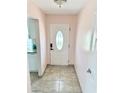 Inviting entryway featuring neutral tile flooring and a stylish front door at 1126 Orwell Ave, Orlando, FL 32809
