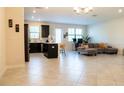 Bright open-concept living area featuring a kitchen with an island and a comfortable seating area at 11378 Whistling Pine Way, Orlando, FL 32832
