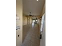 Bright and open-concept living space with tile flooring that flows seamlessly into the kitchen at 13940 Corrine Key Pl, Orlando, FL 32824