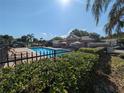 Community pool area with lounge chairs and a clubhouse, perfect for relaxation and socializing at 13940 Corrine Key Pl, Orlando, FL 32824