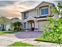 Inviting two-story home featuring a neatly landscaped yard and a spacious driveway at 1425 Carey Glen Cir, Orlando, FL 32824