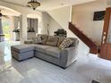 Cozy living space with a plush sectional sofa, modern tile flooring, and seamless flow to other rooms at 1425 Carey Glen Cir, Orlando, FL 32824