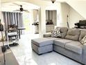 Cozy living room connected to the kitchen, featuring plush furniture and tile floors at 1425 Carey Glen Cir, Orlando, FL 32824