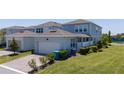 Exterior angle of home with a well-manicured lawn and attached garage in a residential neighborhood at 14309 Lanikai Beach Dr, Orlando, FL 32827