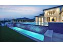 Luxury home featuring a modern pool with tiered waterfall features and meticulously landscaped backyard at 15121 Pendio Dr, Montverde, FL 34756