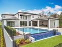 Modern outdoor oasis with infinity pool, built-in outdoor kitchen, perfect for luxury living and entertaining guests at 15121 Pendio Dr, Montverde, FL 34756