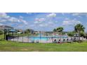 Community pool and splash pad with seating, surrounded by manicured landscaping and beautiful homes at 1556 Aspen Ave, Davenport, FL 33837