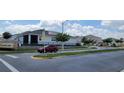 Street view of community landscaping with sidewalks and stylish homes in the Forest Lakes Community at 1556 Aspen Ave, Davenport, FL 33837