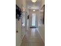 Tiled foyer with a decorative glass front door, coat closet and decor for a welcoming entryway at 2495 Palm Tree Dr, Kissimmee, FL 34759