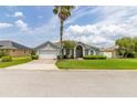 Charming single-story home featuring a two-car garage, manicured lawn, and beautiful landscaping at 252 Barbera Dr, Davenport, FL 33897