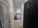 Bright entryway leading into a cozy living room with wood floors and lots of natural light at 2572 Robert Trent Jones Dr # 1227, Orlando, FL 32835