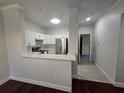 Modern kitchen with white cabinets, stainless steel appliances, and a stylish backsplash at 2572 Robert Trent Jones Dr # 1227, Orlando, FL 32835