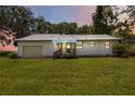 Charming single-story home with a metal roof, a one-car garage, and a well-maintained lawn at 2740 Barker Rd, St Cloud, FL 34771