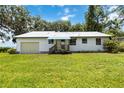 Charming single-story home with a metal roof and well-maintained lawn at 2740 Barker Rd, St Cloud, FL 34771