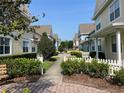 Beautiful street view featuring colorful townhomes, lush landscaping, and a neatly maintained walkway at 4008 San Gallo Dr # 106, Kissimmee, FL 34741