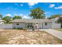 Charming single-story home featuring a well-manicured lawn, white fence, and inviting curb appeal at 416 E Seminole Ave, Lake Wales, FL 33853