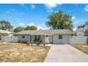 Charming single-story home featuring a well-manicured lawn, white fence, and inviting curb appeal at 416 E Seminole Ave, Lake Wales, FL 33853