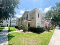 Inviting townhome featuring a well-manicured lawn and lush greenery, adding to its charm at 5356 Diplomat Ct # 108, Kissimmee, FL 34746