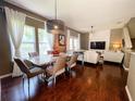 Stylish living room with hardwood floors, modern lighting, and comfortable seating arrangements at 5356 Diplomat Ct # 108, Kissimmee, FL 34746