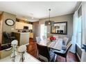 Elegant dining and living area with a stunning dining table and hardwood flooring throughout at 5356 Diplomat Ct # 108, Kissimmee, FL 34746