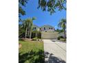 Charming two-story home with a well manicured lawn and beautiful landscaping at 5704 Ansley Way, Mount Dora, FL 32757