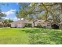 Charming single story home with an expansive lawn and mature trees providing plenty of shade at 7222 Stanford Dr, Lakeland, FL 33809