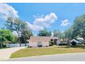 Charming one-story home with lush green lawn, mature trees, and welcoming curb appeal at 7222 Stanford Dr, Lakeland, FL 33809