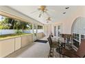 Enclosed patio with tiled flooring, ceiling fans, and views of the landscaped backyard at 7222 Stanford Dr, Lakeland, FL 33809