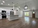 Bright and open living space with cathedral ceilings, wood floors, and adjacent kitchen at 814 Gator Ln, Deltona, FL 32738