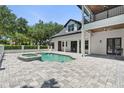 Inviting backyard featuring a pool and spa, seamlessly integrated with the outdoor living space, perfect for relaxation at 9799 Covent Garden Dr, Orlando, FL 32827