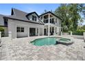 Gorgeous backyard with a refreshing pool, spa and a spacious patio perfect for outdoor entertaining and relaxation at 9799 Covent Garden Dr, Orlando, FL 32827
