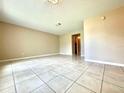 Bright, open living room with ceramic tile flooring and neutral color paint at 1001 Plantation Dr # E1, Kissimmee, FL 34741