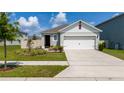 Well-maintained single-story home with a two-car garage, manicured lawn, and charming curb appeal at 1015 Andean Ln, Davenport, FL 33837
