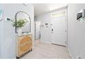 Bright foyer with neutral tile flooring, a stylish accent cabinet, and an inviting entryway at 1015 Andean Ln, Davenport, FL 33837