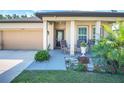 Inviting front porch with rocking chairs, decorative plants, and a well-maintained lawn at 1096 Roberta Rd, Lake Wales, FL 33853