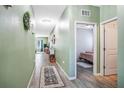 Hallway with modern lighting, wood-look floors, and neutral walls leading to the bedroom at 1096 Roberta Rd, Lake Wales, FL 33853