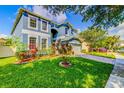 Attractive two-story home with a beautifully landscaped front yard and a paver driveway at 12715 Moss Park Ridge Dr, Orlando, FL 32832