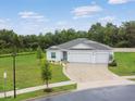 Beautiful home featuring a three-car garage, manicured lawn, and well-maintained landscaping, set in a lush, green neighborhood at 1278 Asher Mason Ave, Kissimmee, FL 34744