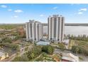 Aerial view of the condo buildings including pool, parking, miniature golf, and surrounding landscape at 13415 Blue Heron Beach Dr # 401, Orlando, FL 32821