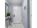 Light and airy entryway featuring marble floors, a white front door and decor at 13415 Blue Heron Beach Dr # 401, Orlando, FL 32821