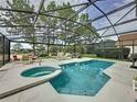 Inviting screened-in pool and spa area with outdoor seating, perfect for relaxation and entertaining at 1426 Park Park, Haines City, FL 33844