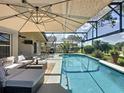 Relaxing screened-in pool area with comfortable lounge furniture and dining set for outdoor entertaining at 1428 Park Pl, Haines City, FL 33844
