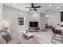 Open living space boasting tile floors, a comfortable gray sofa, and views into the modern kitchen at 14344 Swanley St, Orlando, FL 32832