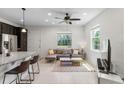 Bright living room featuring tile flooring, recessed lighting, a ceiling fan, and two large windows at 14344 Swanley St, Orlando, FL 32832